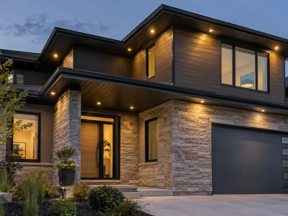 Warm soffit lights spaced along a two-storey roofline.